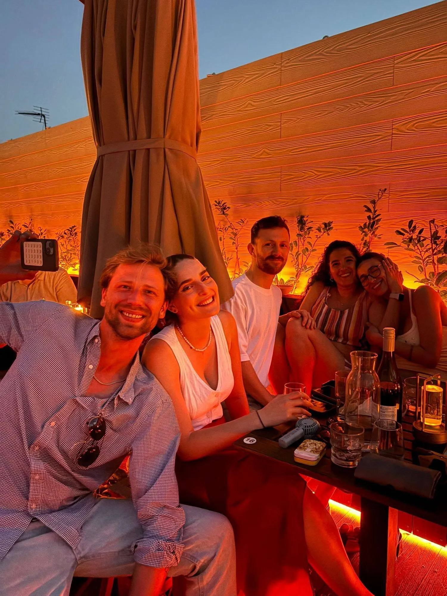 Friends on a rooftop at sunset